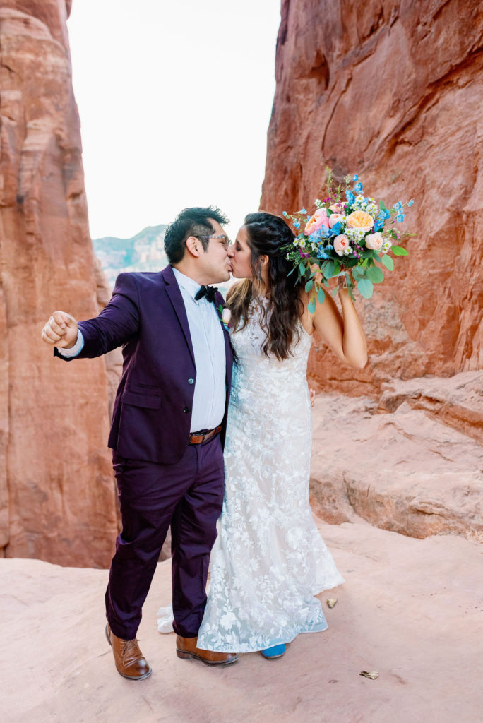 bride and groom kiss on top of mountain sedona arizona 