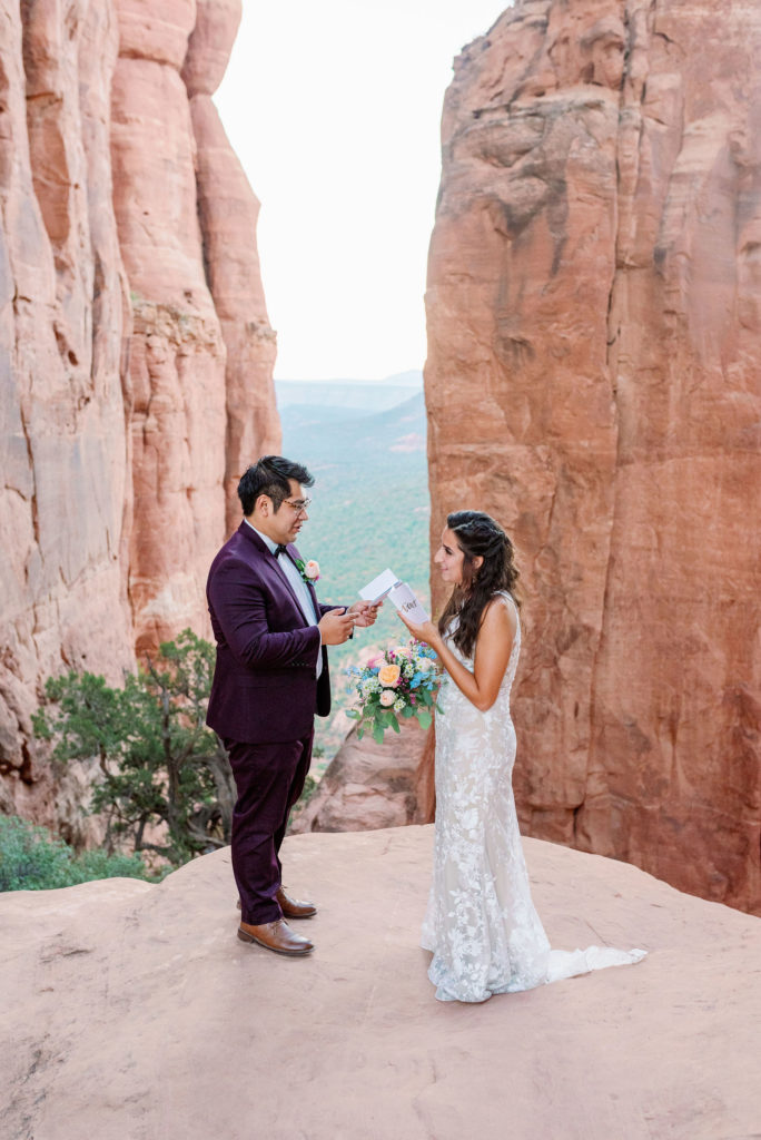Sedona arizona Elopement Cathedral Rock reading vows on top of moutain