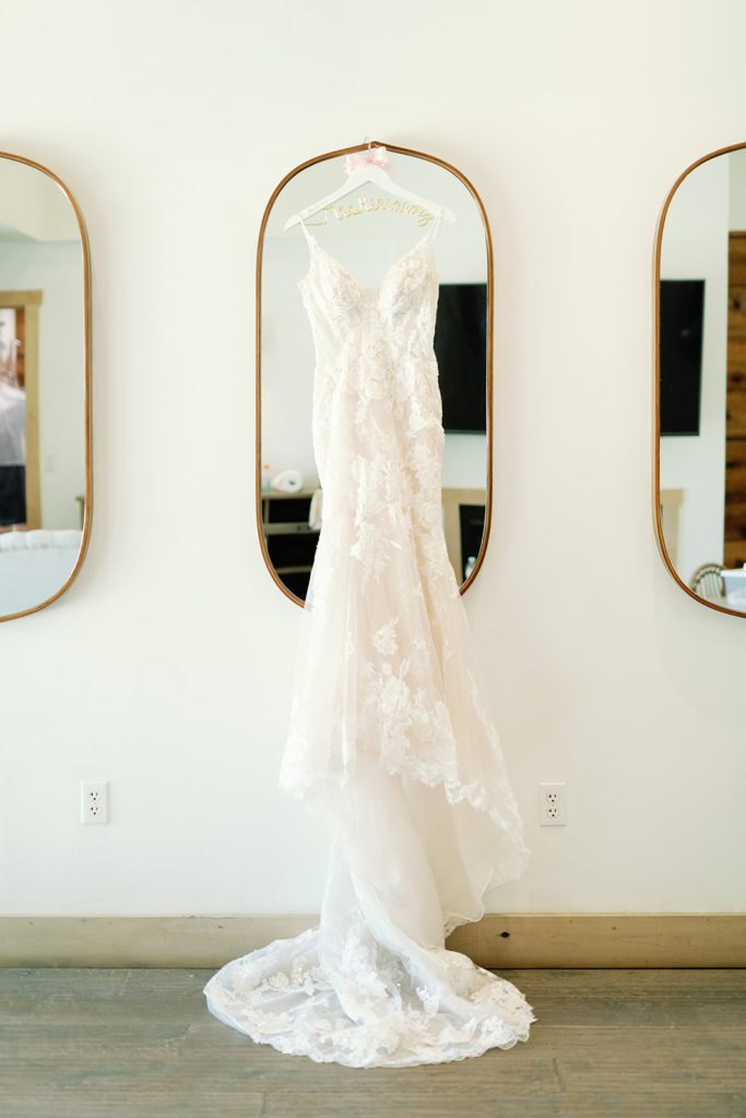 wedding dress hanging on mirror 