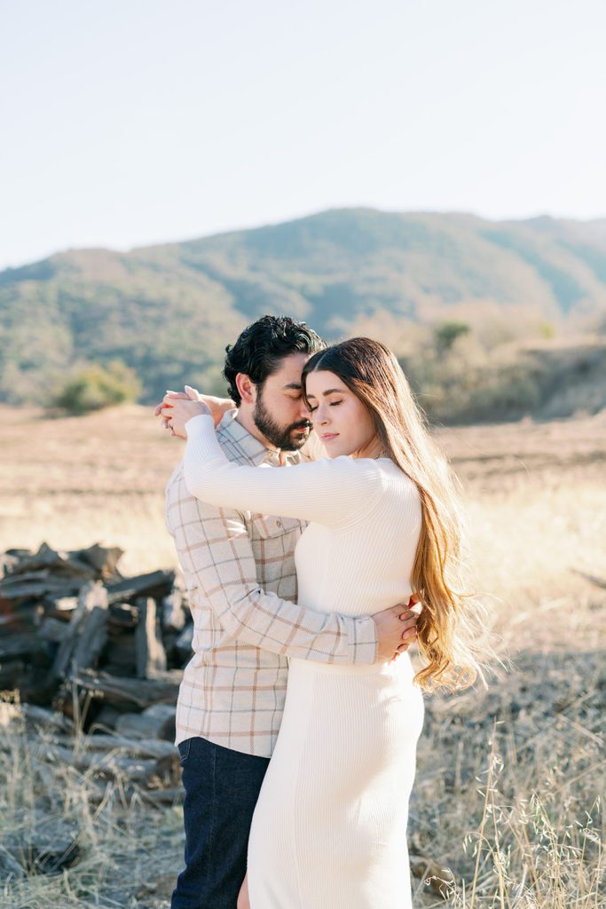 Temecula California engagement photographer, couple in open field, touching heads  