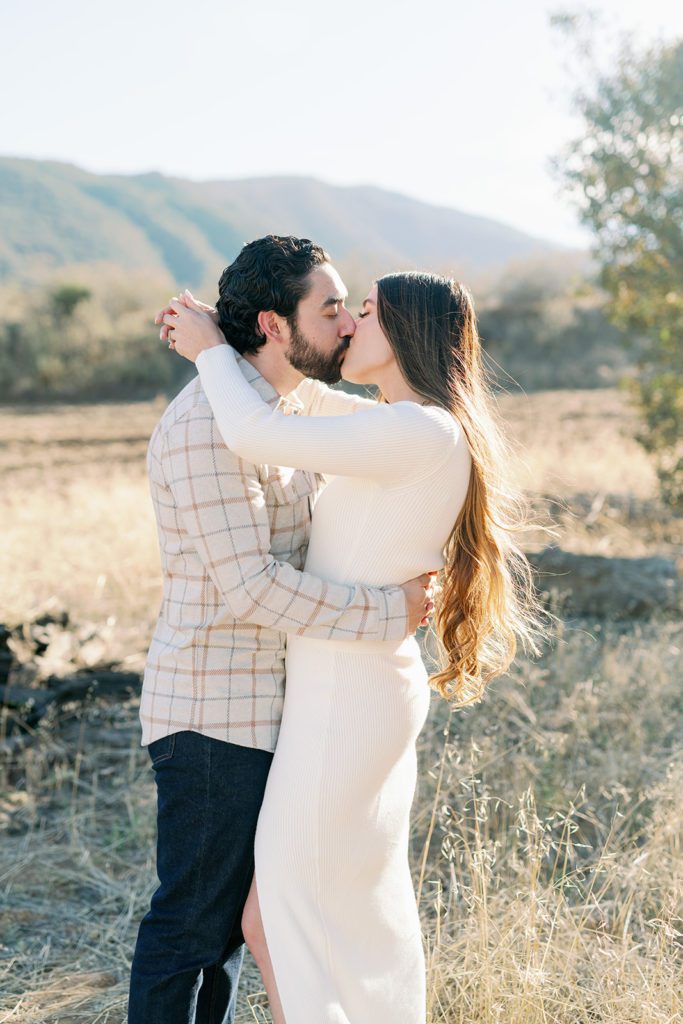 corona California engagement photographer couple in open field kissing 