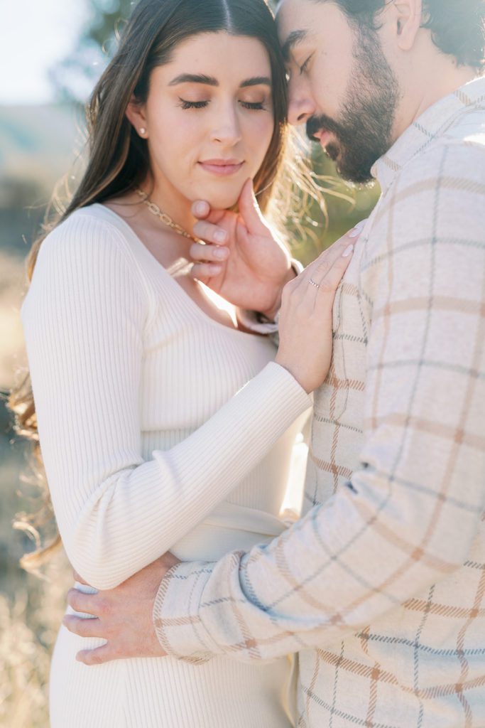 couple engagement photos with light and airy style Temecula California, hand on chiin 