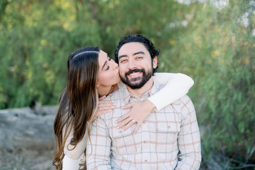 couple engagement photos with light and airy style Temecula California, girl kisses cheek  