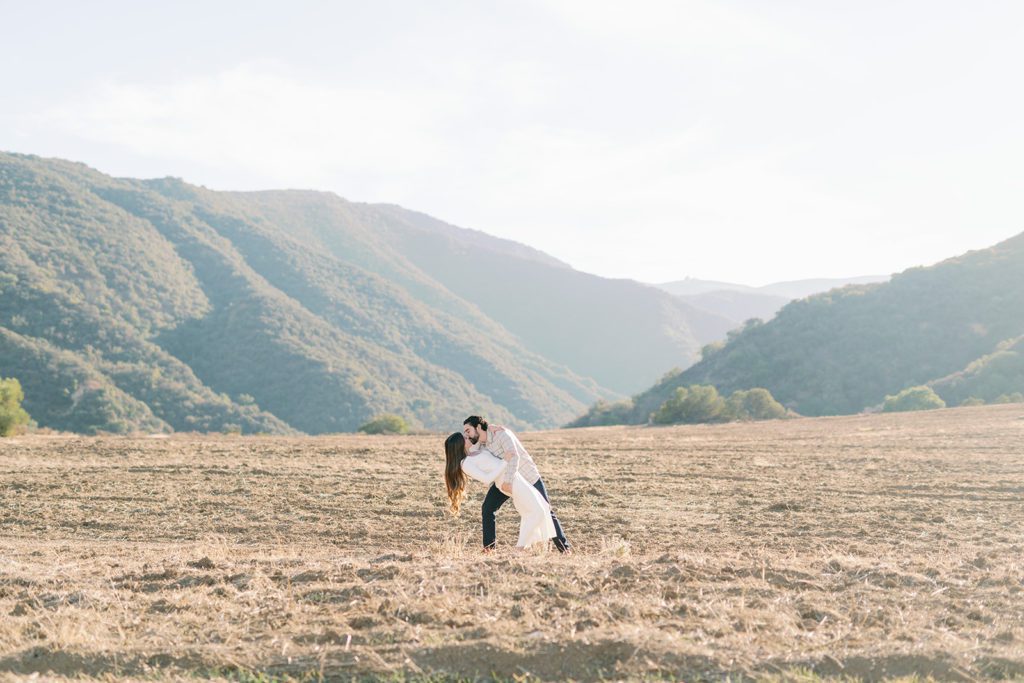 corona California engagement photos in open field with kiss dip
